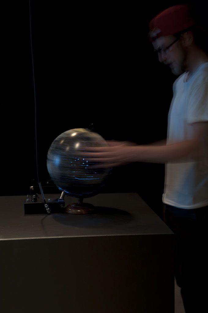 In Solidarity: The Workers of the World, visitor interacting with globe